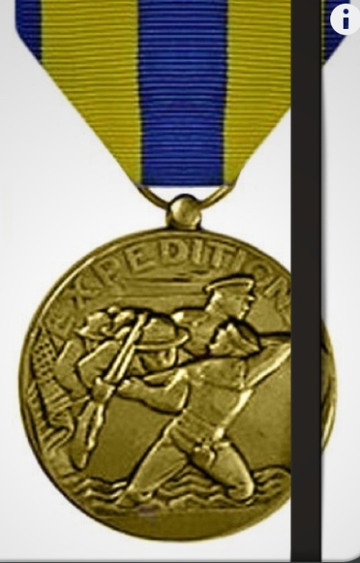 Photo of US Navy Expeditionary Medal on a notebook cover