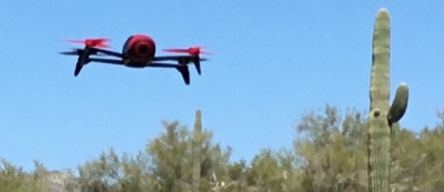 Photo of Bebop 2 drone in flight next to a saguaro cactus